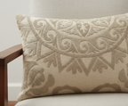 Decorative pillow with intricate patterns on a neutral background