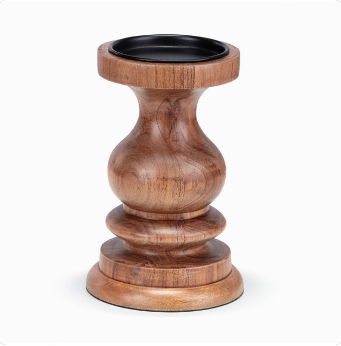 A small acacia wood pillar candle holder with a rounded base and a tapered shape, with a black lid on top.