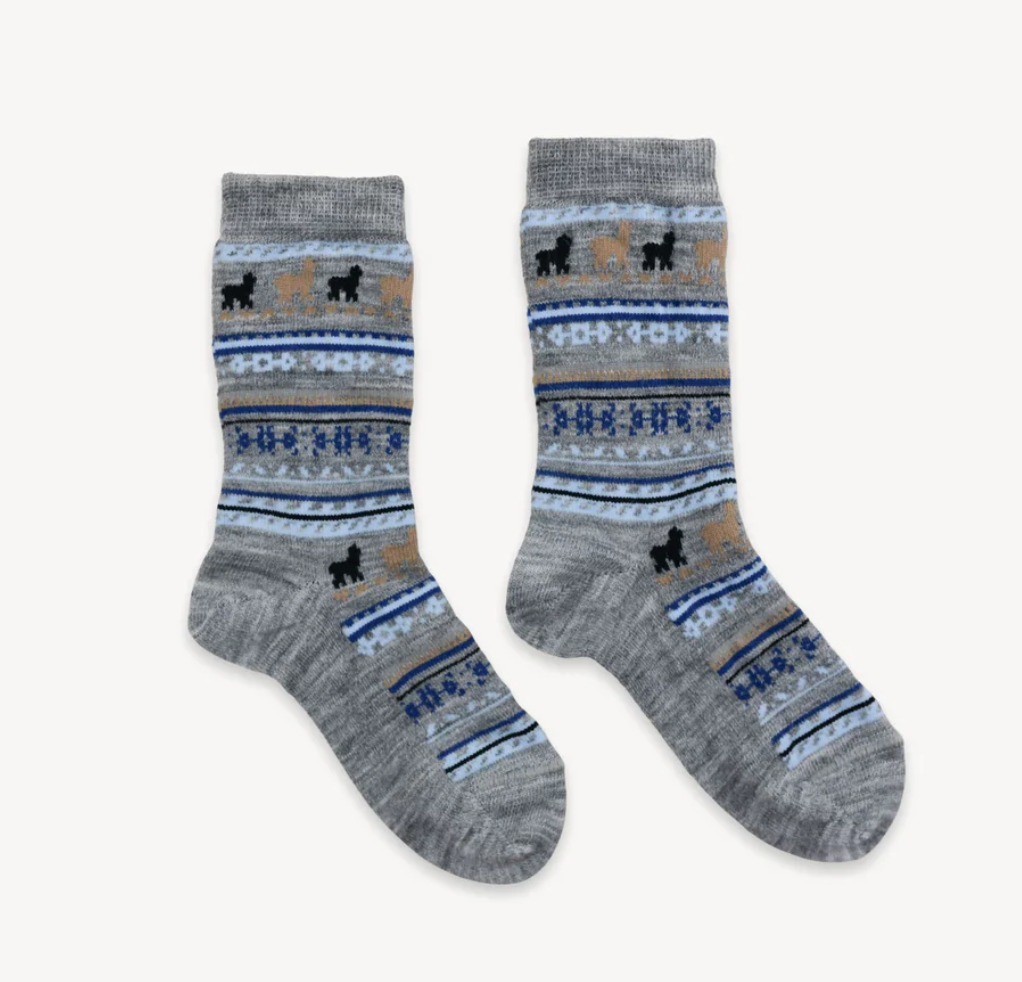 Pair of gray alpaca blend socks with blue, white, brown and black pattern and black design on a background