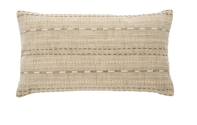 A rectangular-shaped beige cushion with embroidered detailing on one side, placed against a white background.
