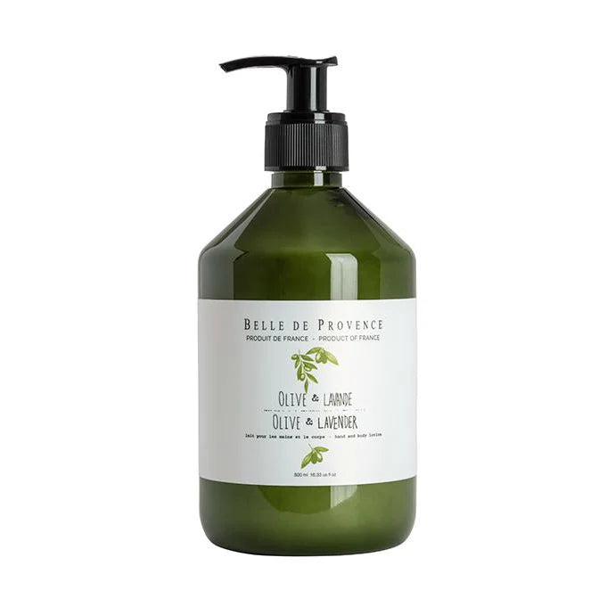 A bottle of Belle De Provence hand and body lotion with olive and lavender label, placed on a wooden surface.