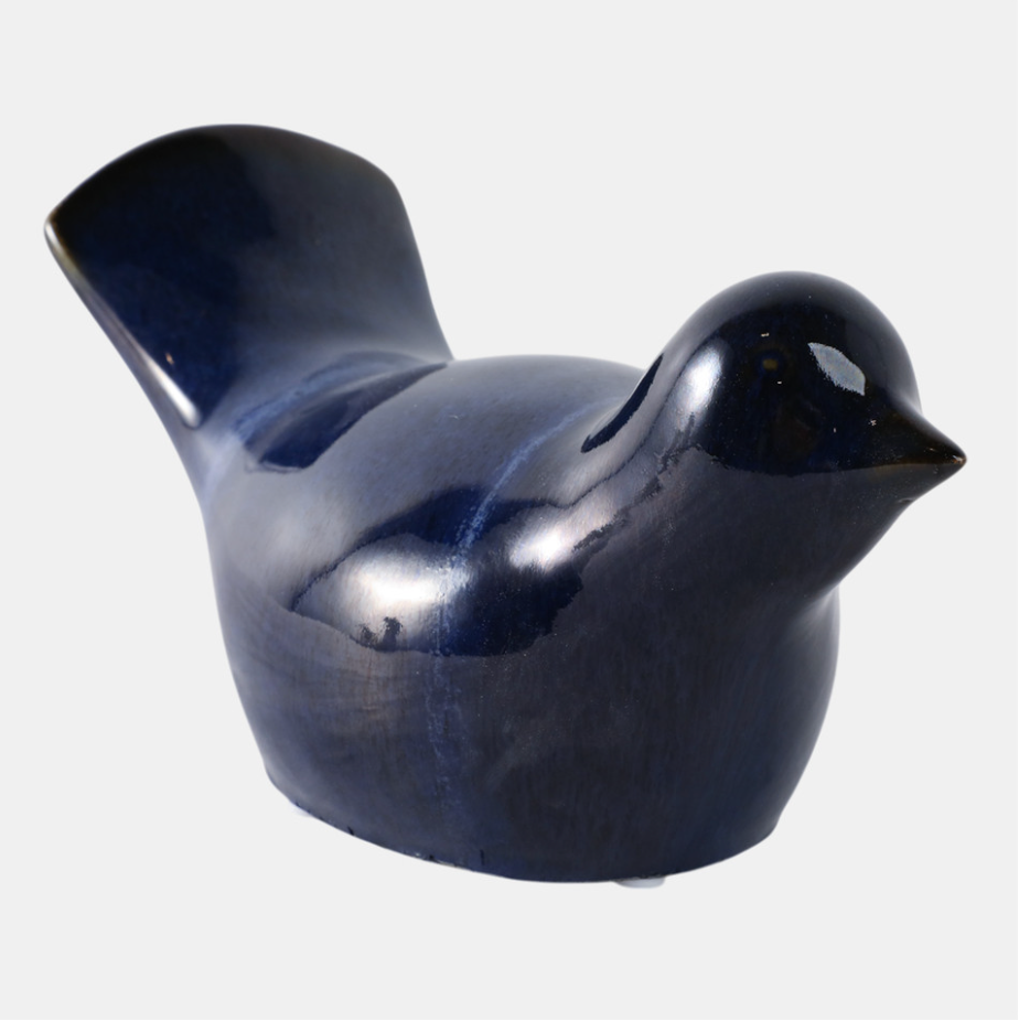 Glossy blue ceramic bird-shaped object on a white background