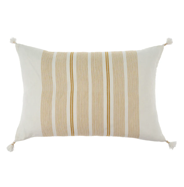 A rectangular linen pillow with woven ochre stripes and hand-wrapped tassels at each corner.