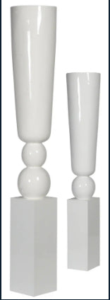 Two white, funnel-shaped pillar vases with a smooth glossy finish, one larger than the other, set against a plain background.