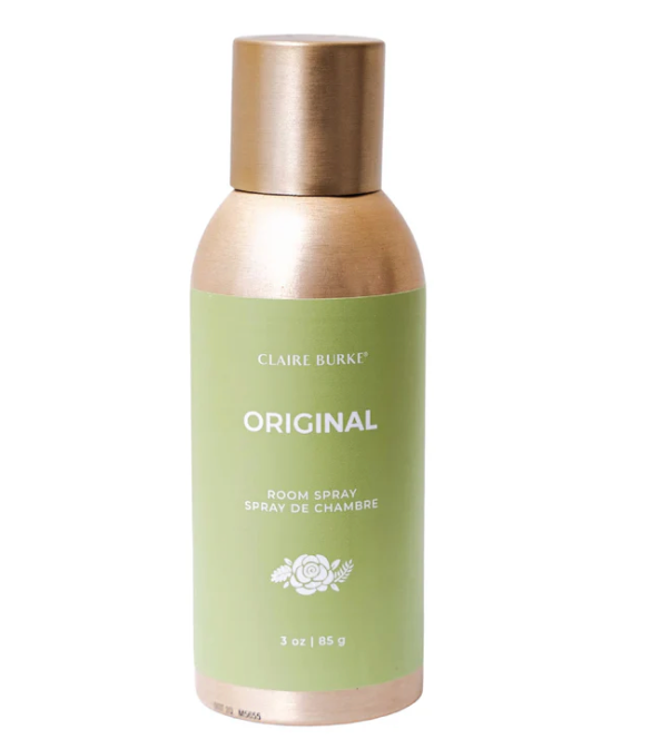 A bottle of Claire Burke Original room spray with a green label and gold cap.