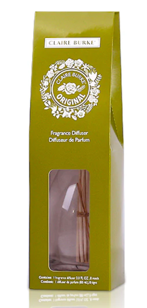 Packaged Claire Burke fragrance diffuser with clear glass container and reeds visible inside, green and white product label, ready for gift-giving.