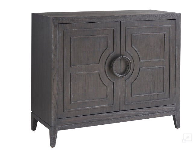 A brown Cordilia Accent Chest with wooden carvings and a Ravenwood finish.