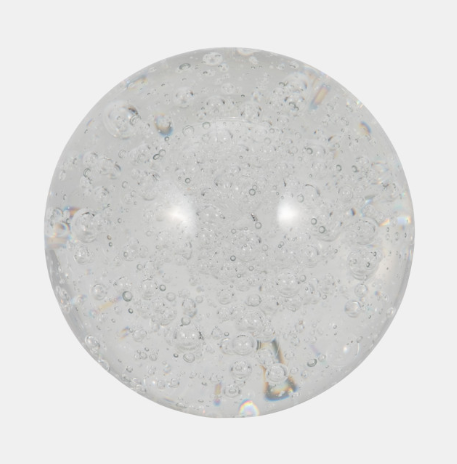 A clear glass spherical paperweight.