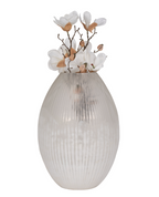 Decorative vase with ribbed design and white flowers on a white background