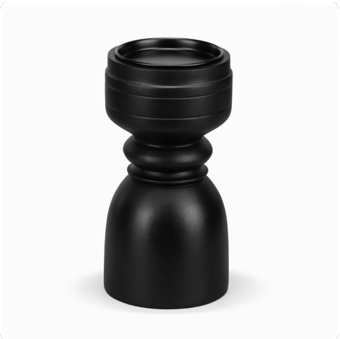 A large black ebony wood pillar candle holder.