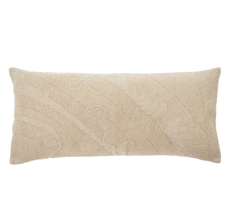 A beige cushion with an abstract floral pattern, rectangular in shape.
