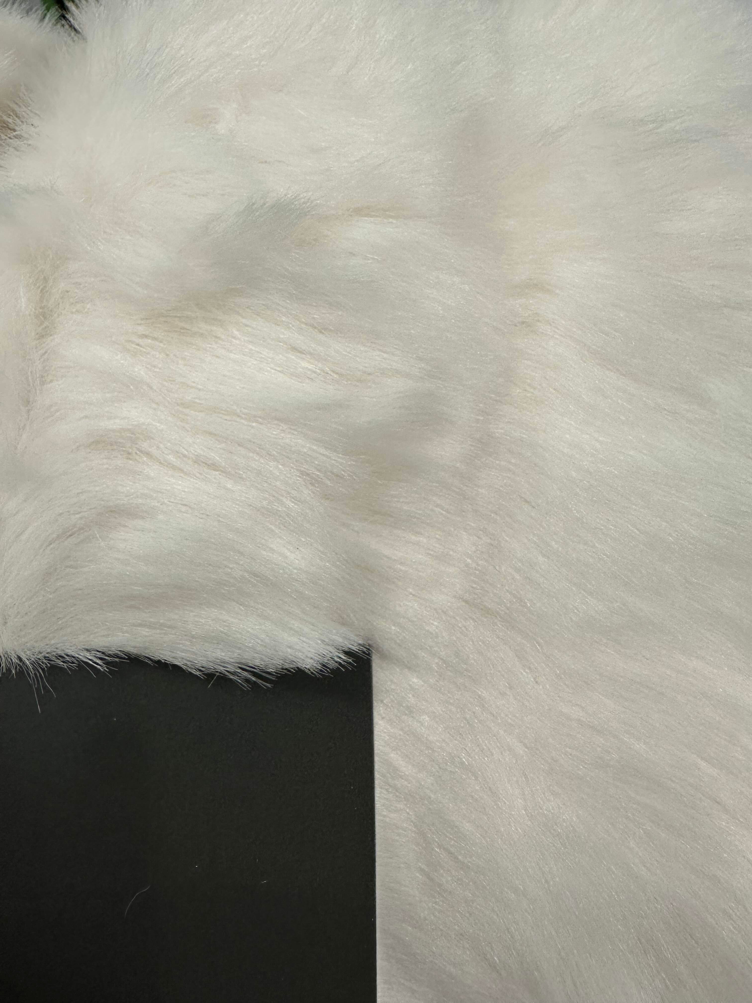Close-up of white fluffy faux fur fabric.