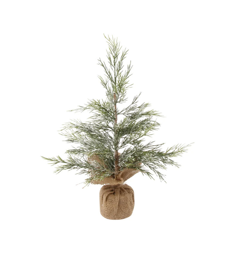 Small artificial Christmas tree in a burlap bag on a white background