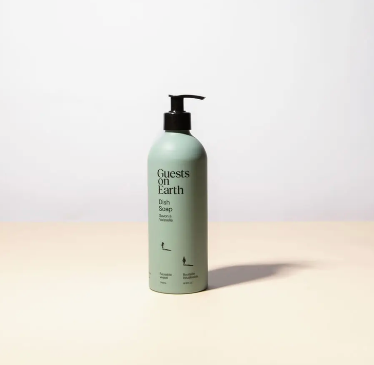 Bottle of 'Guests on Earth' dish soap on a light background