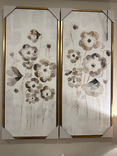 Two pieces of artwork with grey and black watercolour flowers on a white grey background with a gold frame. 