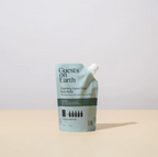 Foaming hand soap refill packaging with 'Guests on Earth' branding on a beige background.