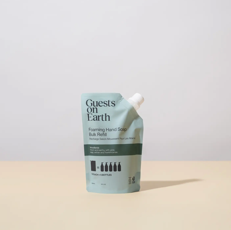 Foaming hand soap refill packaging with 'Guests on Earth' branding on a beige background.