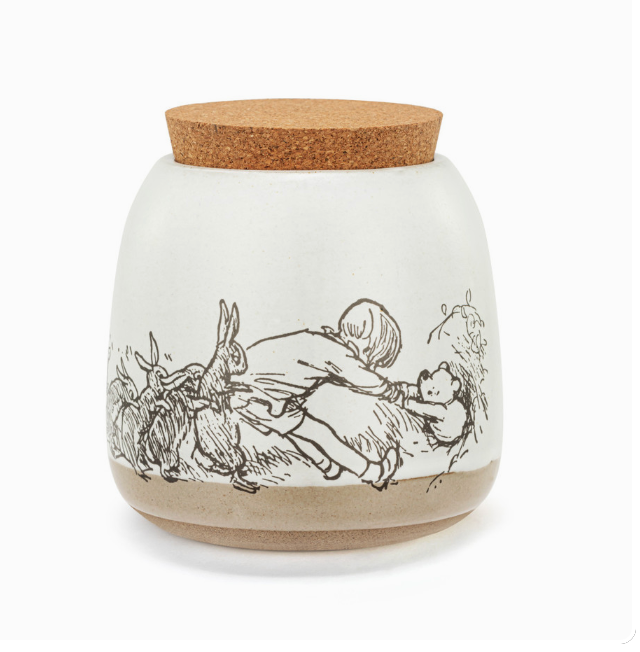 A white ceramic canister with a cork lid, featuring black and white illustrations of Winnie-the-Pooh and friends.