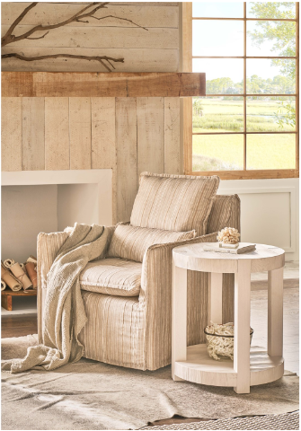 Light wash wooden round side table in a rustic living room. 