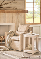Light wash wooden round side table in a rustic living room. 