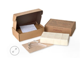 A 32oz Himalayan Trading wax tart refill kit in an open brown box, with a white wax block and a note inside the box.