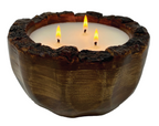 A reclaimed mango wood candle bowl with 3 lit wicks on a white background. 