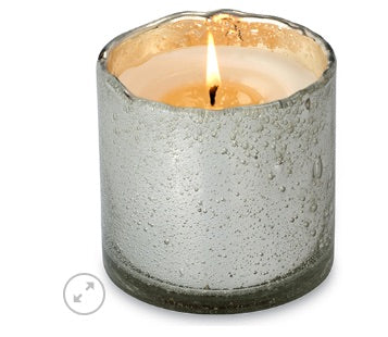 Iridescent smoke grey, blown glass tumbler candle on a white background. 