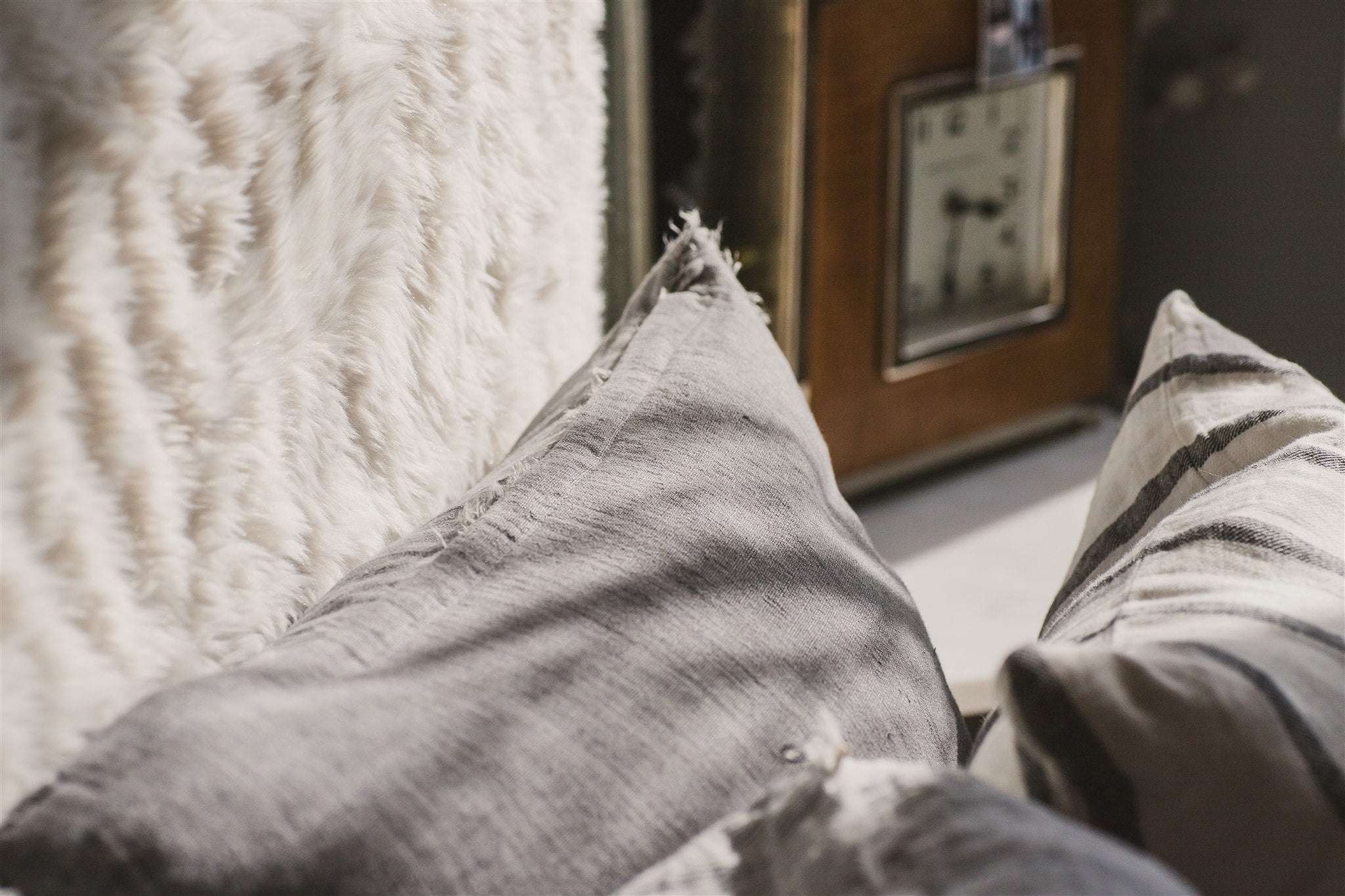 Close-up of textured pillows on a sofa with a blurred background