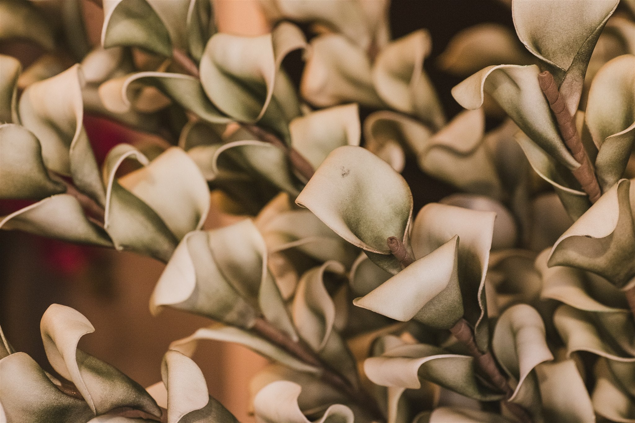 Close-up of decorative faux green leaves with a blurred background