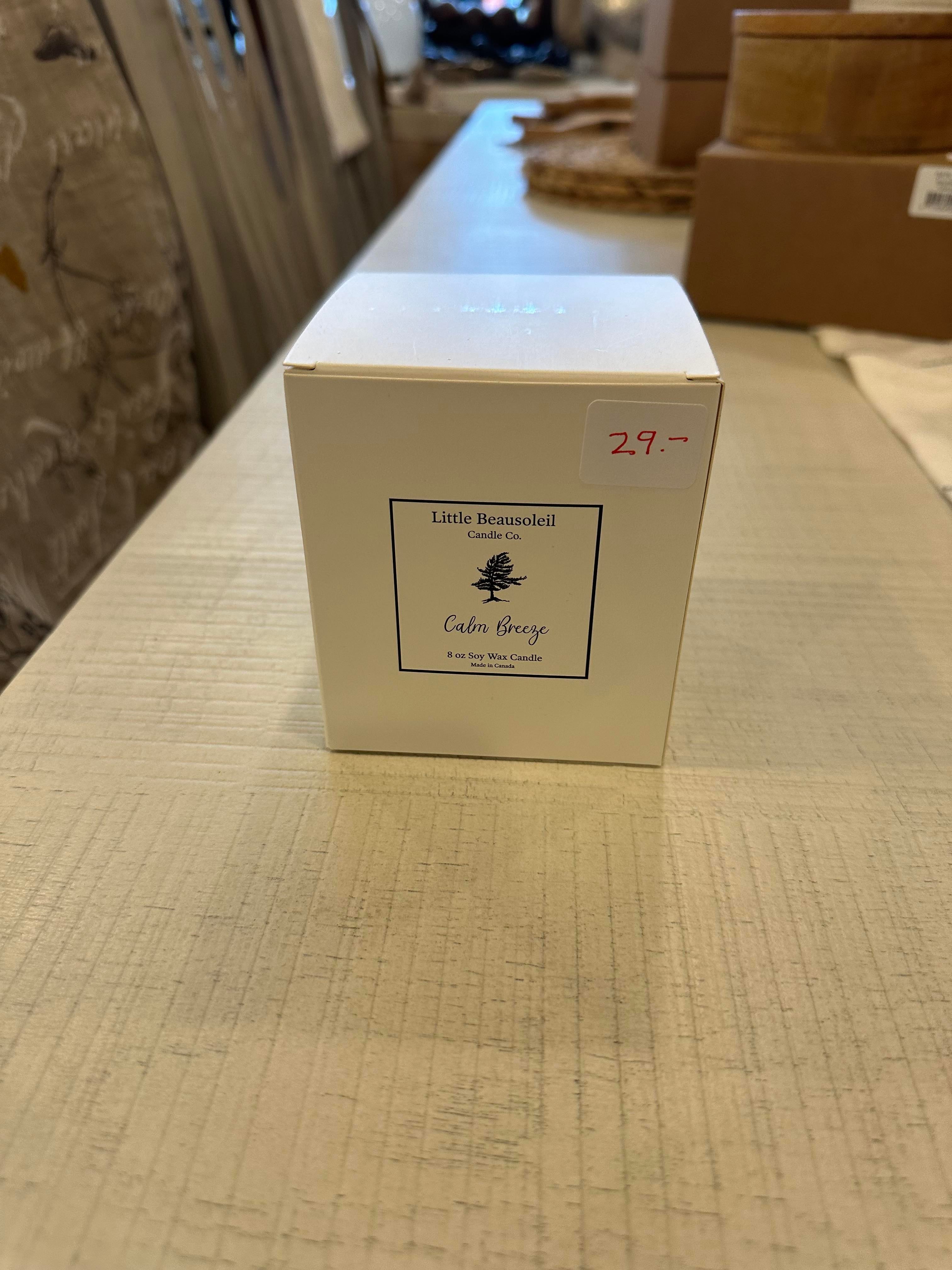 This image features a stylishly packaged jar candle named "LB Jar Candle - Calm Breeze". The candle comes in a square, frosted glass jar that reflects a subtle, warm light, enhancing its aesthetic appeal.