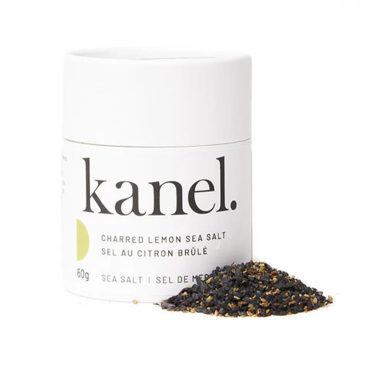 white Cylindrical package of Kanel Charred Lemon Sea Salt with a small pile of spices. 