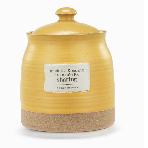 A yellow ceramic jar with a lid, featuring a label with the text 'kindness & caring are made for sharing' and a space for a name.