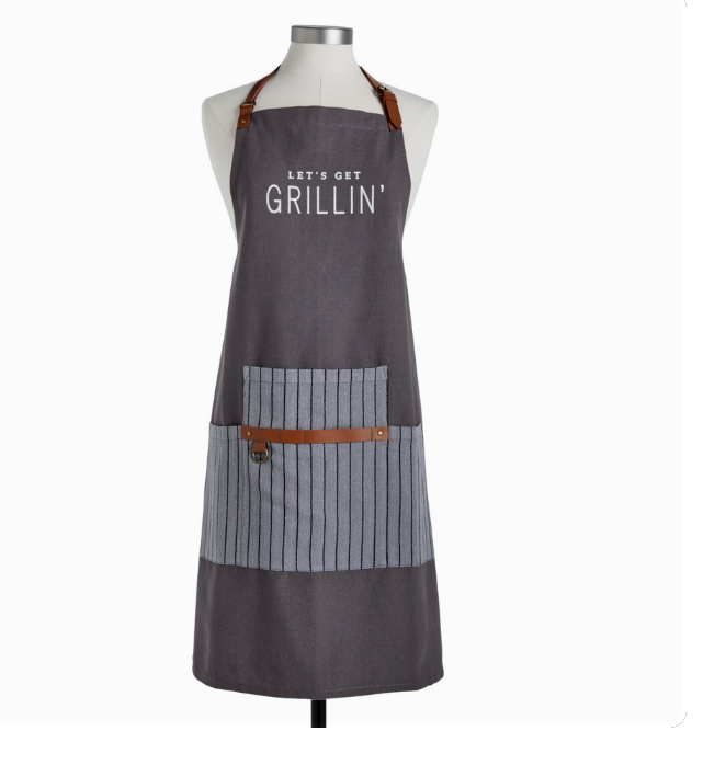 A gray apron with the text 'LET'S GET GRILLIN'' printed on the chest area, featuring a striped pattern and a faux leather strap.