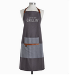 A gray apron with the text 'LET'S GET GRILLIN'' printed on the chest area, featuring a striped pattern and a faux leather strap.