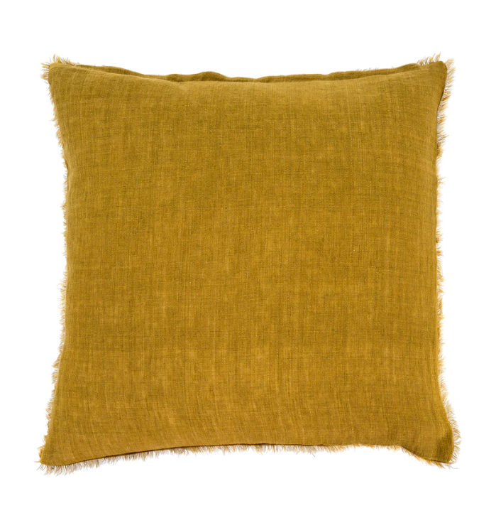 A square-shaped cushion with a solid cumin color, featuring a frayed edge texture.