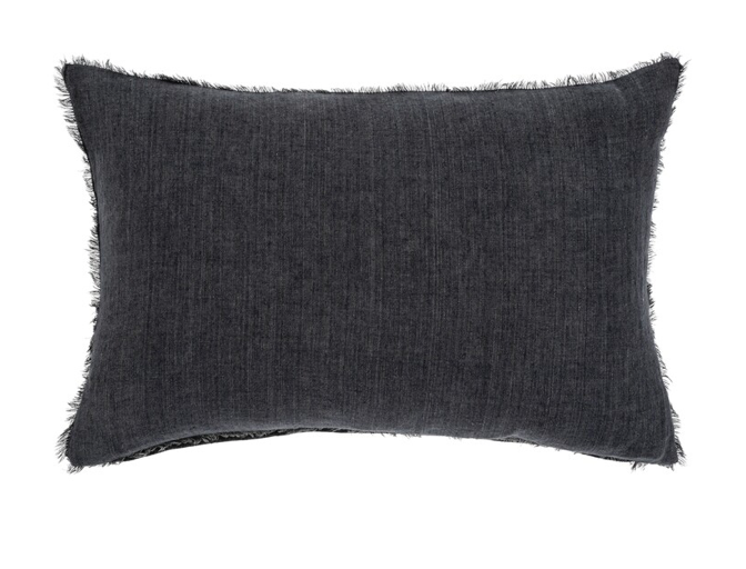 A black rectangular linen cushion with a textured design and a fringe edge.