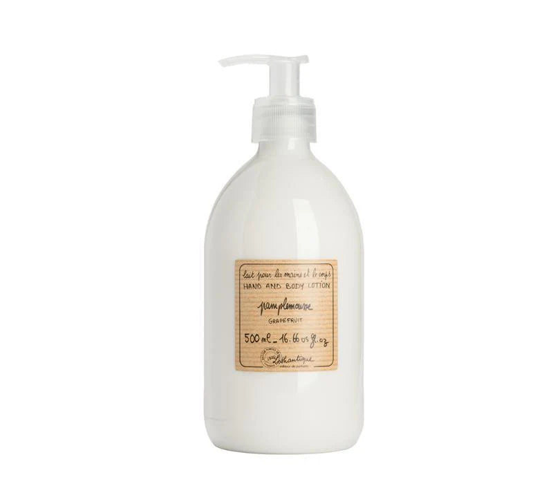 A pump bottle of Lothantique grapefruit hand and body lotion positioned on a wooden surface with a label that includes the product name and volume information.