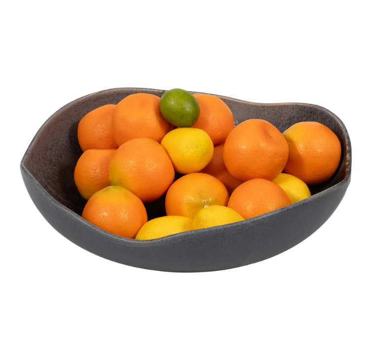 Dark brown ceramic bowl with curved edge, filled with oranges and limes. 