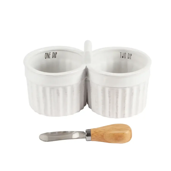 Two white porcelain dip bowls attached at the middle with the text "ONE DIP" and "TWO DIP" and a wooden handled spreading utensil 