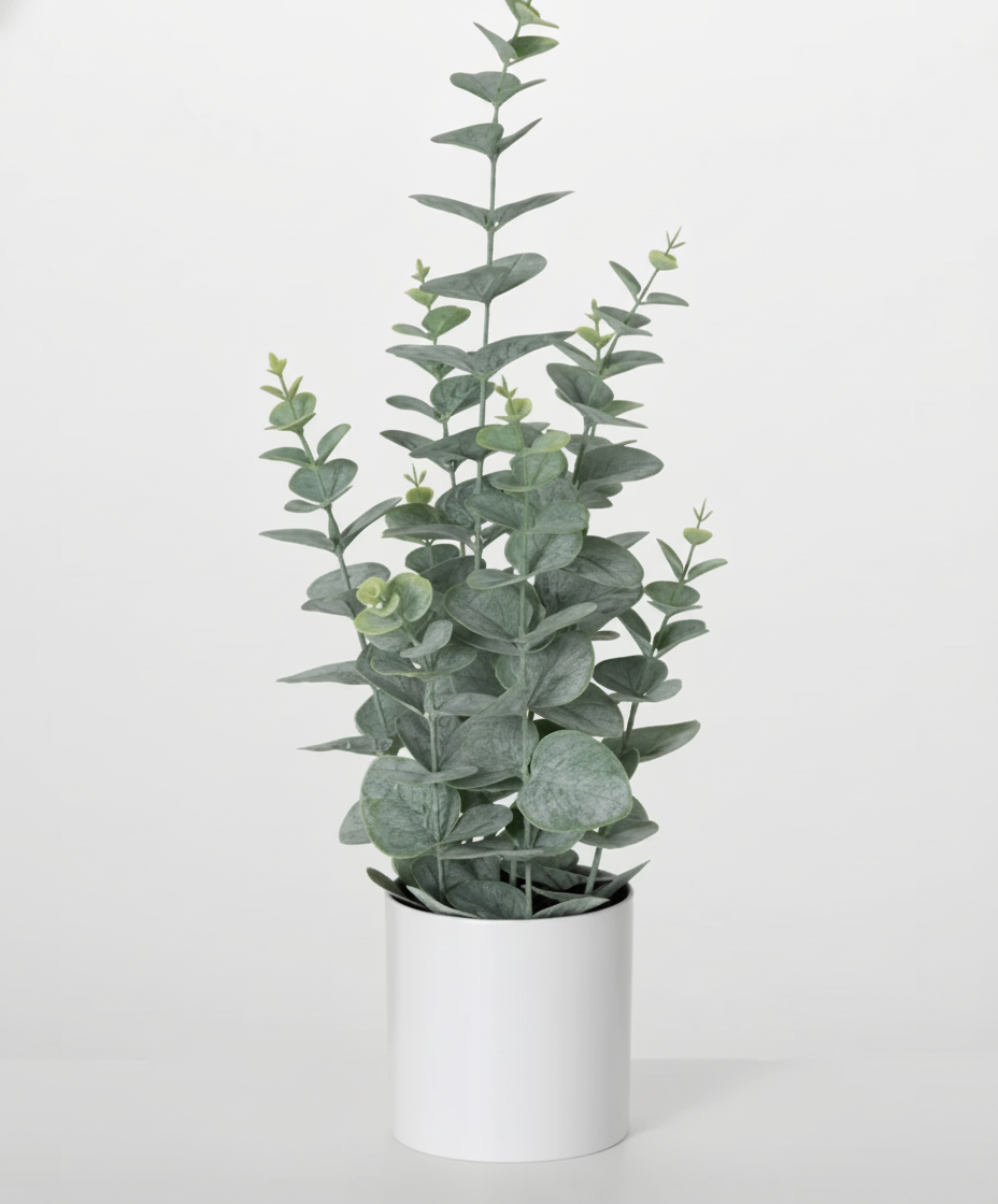 A potted artificial eucalyptus plant with green leaves in a white container.