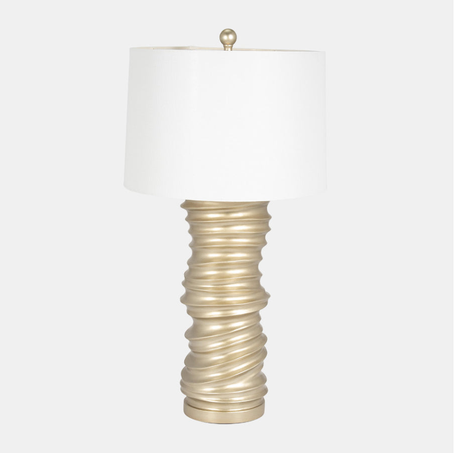 A champagne-colored resin table lamp base supporting a white lampshade, designed for stacking.