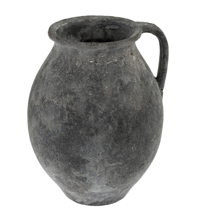 A black, stone-textured pitcher vase with a handle on the side.