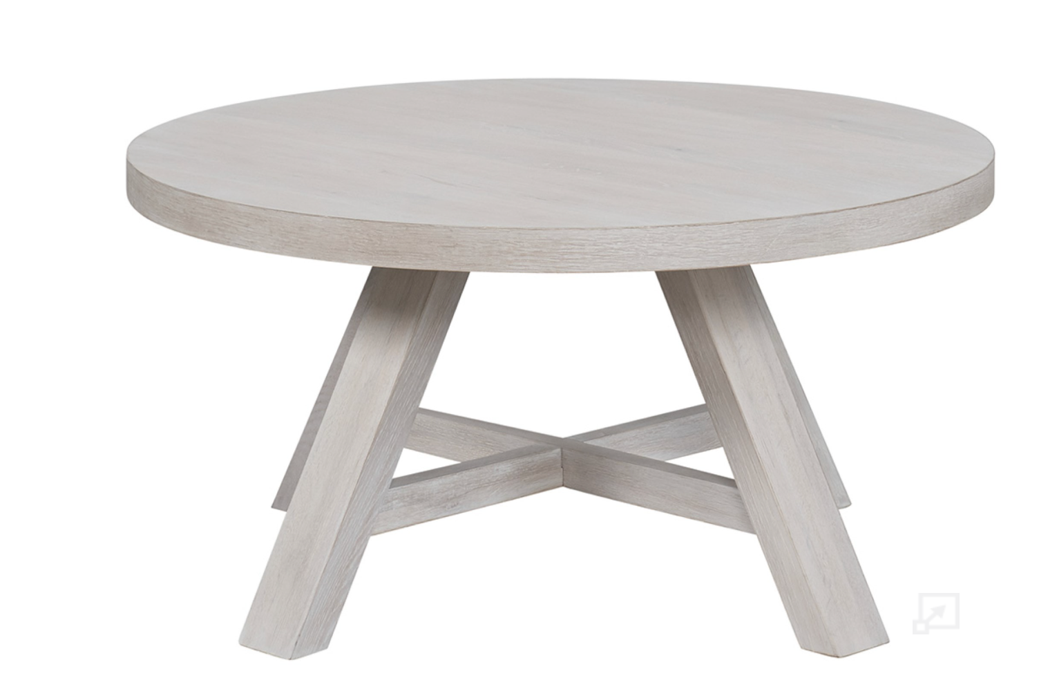 A round cocktail table with a buttermilk finish and broad angled legs.