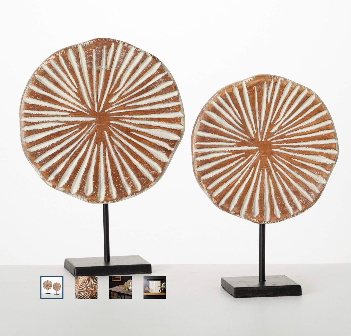 Two wooden disc figurines on matte black pedestals, with the discs having a circular embossed pattern.