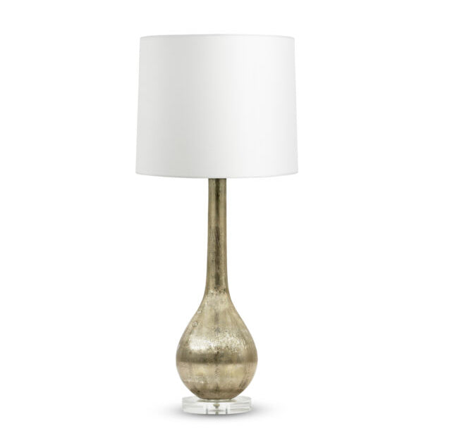 Table lamp with mouth-blown glass, beige metallic finish on an acrylic base, with a tapered white drum lamp shade, on a white background. 