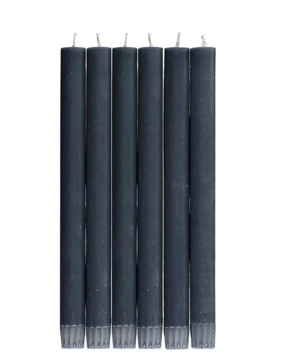 A set of six solid color blue dinner candles presented in a lined gift box.