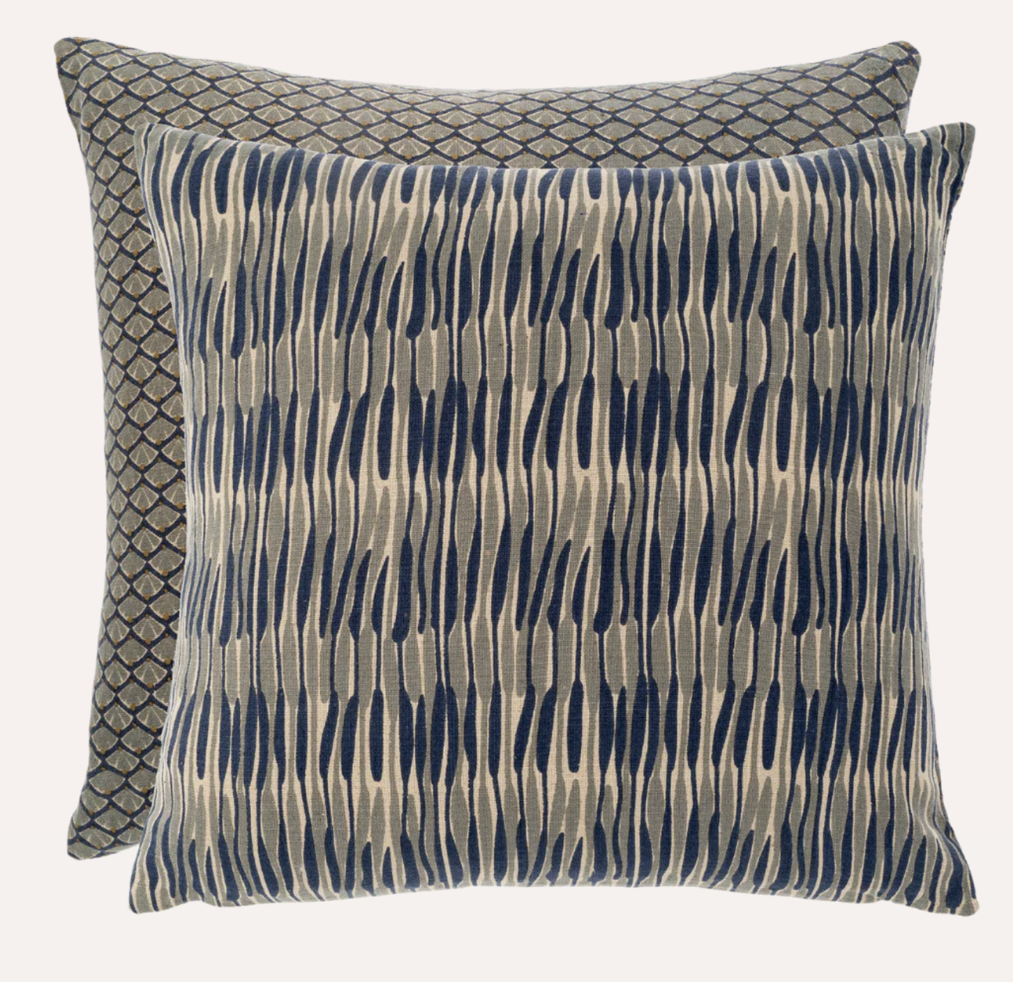 Double Sided square throw pillows, one side with a blue and neutral ripple pattern and the other with a shell inspired pattern.