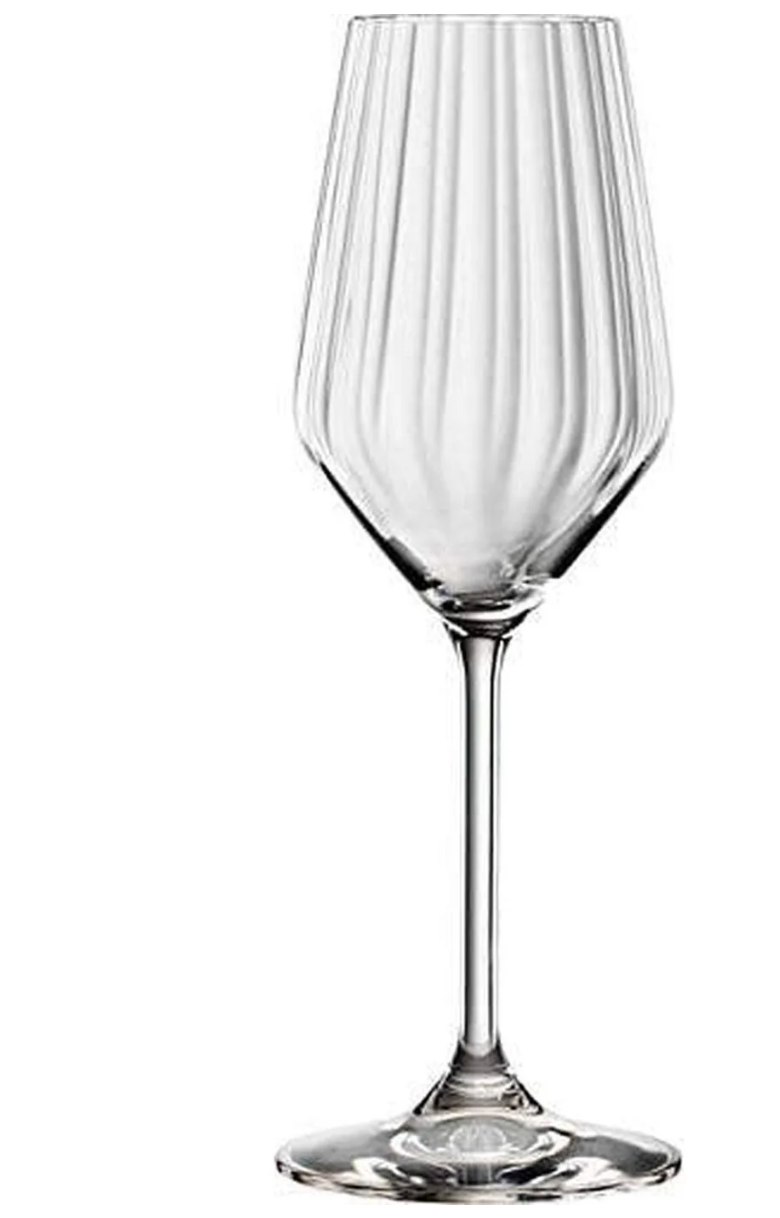 A clear glass cocktail glass with a geometric pattern design.