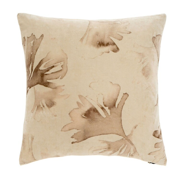 A square-shaped beige throw cushion with a brown floral pattern. 