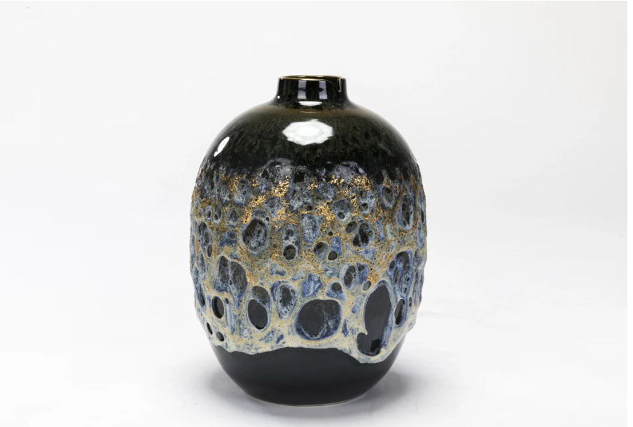 Black and gold ceramic vase on a white background